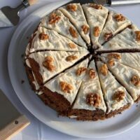 Carrot cake with cream cheese and walnut topping