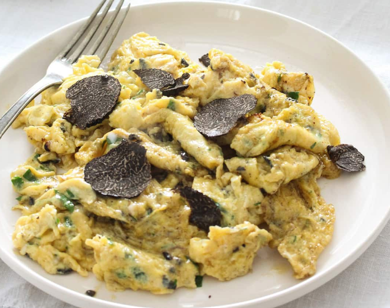 scrambled eggs and black truffle, luxury christmas day or new year's day breakfast